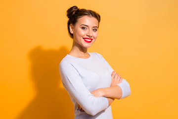 Obraz premium Profile side view portrait of her she nice-looking attractive lovely fascinating winsome content cheerful cheery girl folded arms isolated over bright vivid shine yellow background