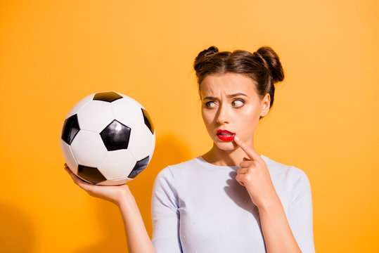 Close up photo beautiful hairdo she her lady judge referee hold raise hand arm leather ball finger chin mouth hate football afraid to be injured wear casual white pullover isolated yellow background