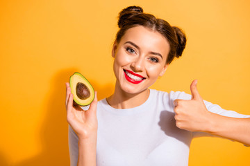 Close up photo beautiful she her lady pretty hairdo hold slice avocado show thumb up advising use...