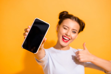 Close up photo of funky energetic student showing her mobile phone agreement appreciation wearing...