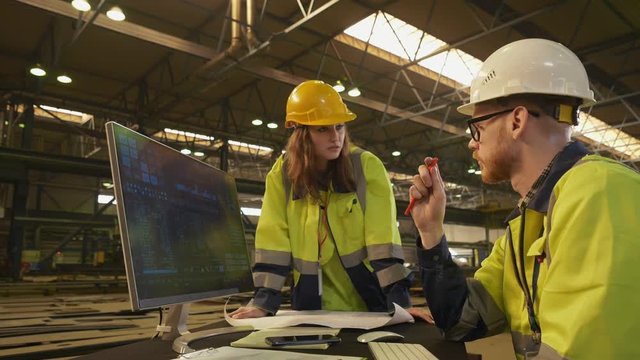 Two maintenance engineers working on computer