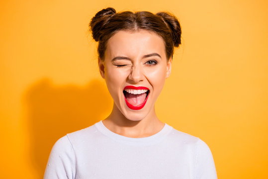 Close up portrait of lovely cute funny lady making winks opening her mouth shouting yeah having holidays dressed in white comfortable clothing isolated on bright background
