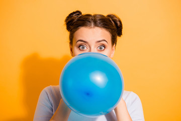 Close up photo of cute lovely hipster party maker preparing festive surprise for her boyfriend friends putting lips to inflate balloon wearing white sweater isolated on vivid background