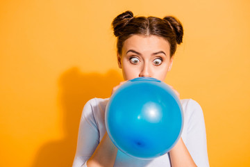 Close up photo of funky childish cheerful lady impressed by size of ballon for festivals carnivals celebration anniversary. Dressed in white cotton outfit isolated over vibrant background