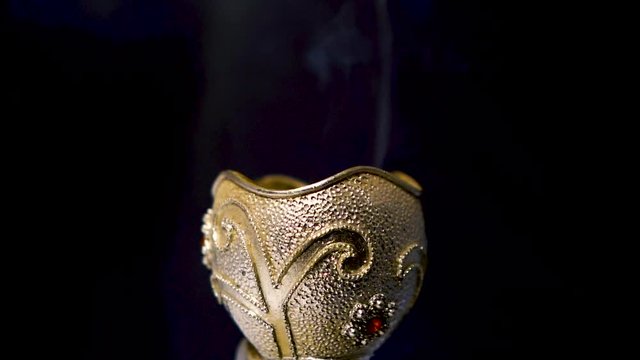 Burning incense against a white background, emirate and Saudi traditions bakhoor, oud wood