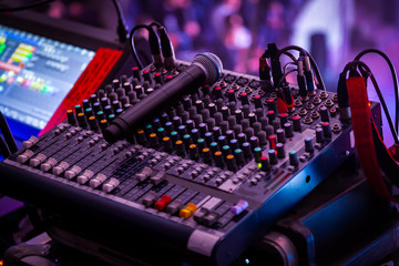 Night club, the concept of nightlife and theatrical life. Professional mixing console at a concert....