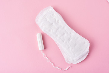 Sanitary pad and menstrual tampon on a pink background