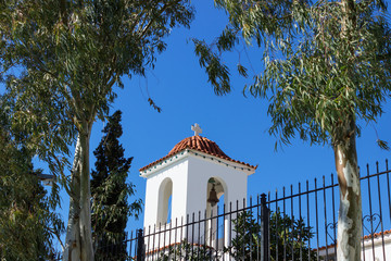 Little beautiful Greek church in blue and white colors on a sunny day against the blue sky on the...