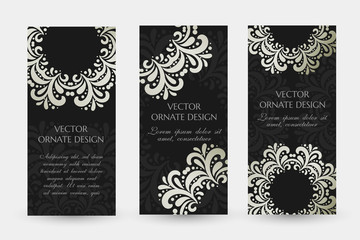 Silver floral motif. Luxury vertical flayers with ornaments on the black background.