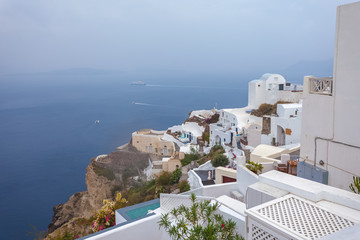Panorama of houses in the village of Oia and the caldera on a rare rainy day