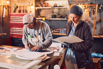 Couple working together in a retro vintage garage.