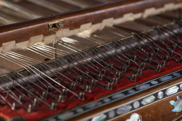 ancient Asian stringed musical instrument on black background with backlight. the similarity of the harp and psaltery. close-up