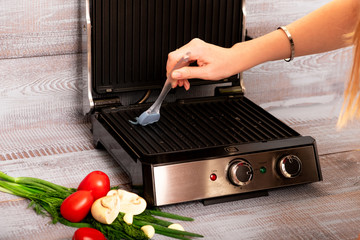 Beef steak with vegetables. Preparation on electric grill