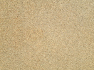 Fototapeta na wymiar Top view of sandy beach. Background with copy space and visible sand texture. Detail of surface texture with small pebble rock on dirty ground and surface for background, Top view.