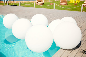 white balloons in the pool with clear water