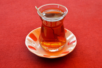 cup of Turkish tea on red background