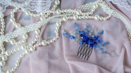 Wedding background with pearls and hair accessories on pink background