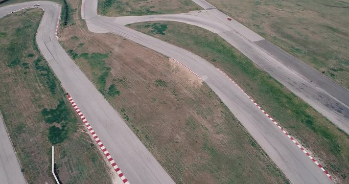 Aerial Footage Of Car Racing Track With Corners Championship Driving Cinematic Look Asphalt Burned Tires  Cloudy Day High Speed Cornering 