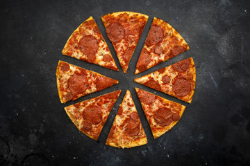 Italian pizza pepperoni on dark stone background