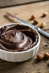 Chocolate and nut paste on wooden table