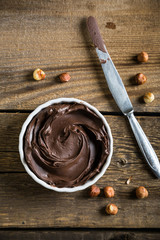 Chocolate and nut paste on wooden table