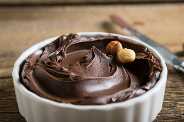 Chocolate and nut paste on wooden table