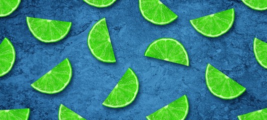 Sliced juicy lime and lemon on a concrete dark blue background. Fresh fruits. Fruit background. Healthy food. Vitamins. Summer party. Birthday.