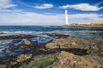 Fototapeta premium Rocky coast and white lighthouse
