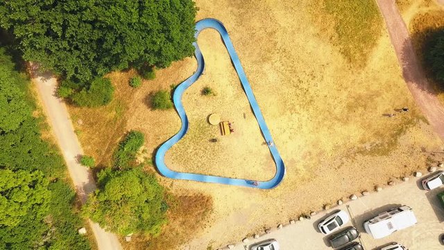 Aerial, birdseye, drone shot, above people skating at a skate ramp, on a sunny summer day, in Sweden