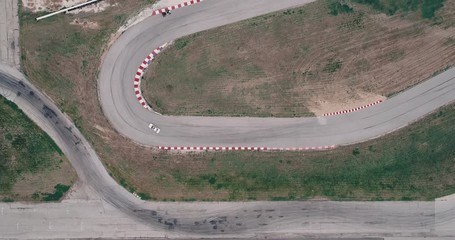 Aerial Footage Of Car Racing Track With Corners Championship Driving Cinematic Look Asphalt Burned Tires Cloudy Day High Speed Cornering - Powered by Adobe