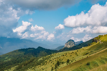 Naklejka premium Beautiful summer mountain landscape with clouds and a sunny day.