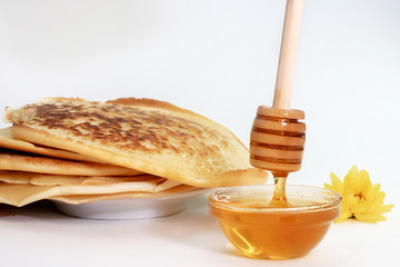 pancakes and honey for Breakfast on a light background