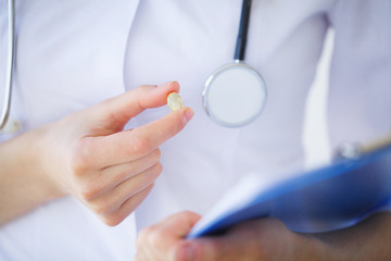 Medicine. Doctor woman holding blister pack pills