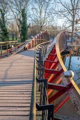 Fototapeta na wymiar Wooden bridge on the lake of Minnewater Park in Bruges