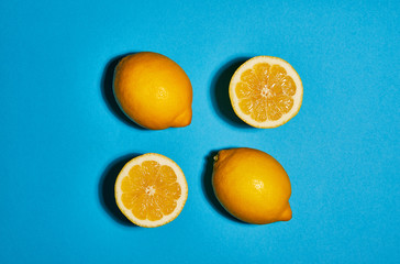 Lemon on blue background. Flat lay, top view, copy space . Food concept.