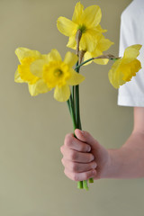 yellow flowers in a male hand