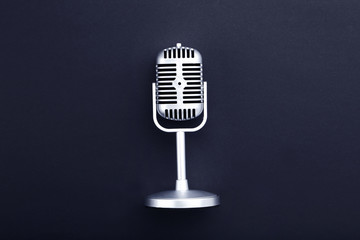 Vintage microphone on black background