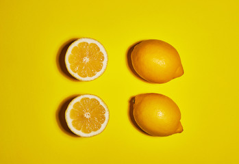 Lemon on yellow background. Flat lay, top view, copy space . Food concept.