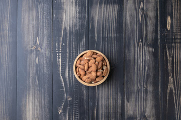 close up of almond on wooden plate