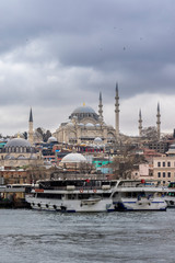 Fototapeta premium Cityscape of Golden horn with ancient and modern buildings at Bosphorus strait in Istanbul Turkey with background of Suleymaniye mosque