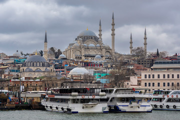 Fototapeta premium Cityscape of Golden horn with ancient and modern buildings at Bosphorus strait in Istanbul Turkey with background of Suleymaniye mosque
