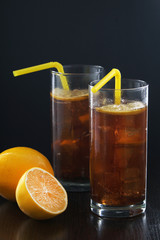 Glasses with cuba libre cocktail or cola with ice or cold tea with lemon