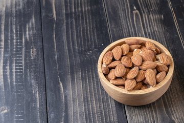 close up of almond on wooden plate