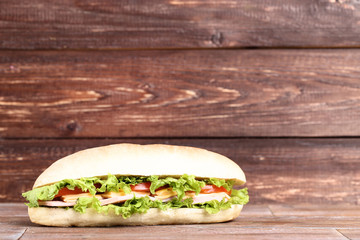 Fresh sandwich on brown wooden table
