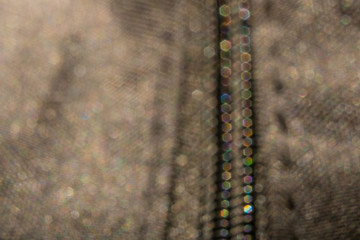 Defocus with colored bokeh zipper on a dark jacket in macro photography