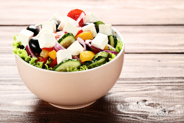 Vegetable salad in bowl on brown wooden table