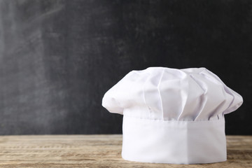 Chef hat on wooden table