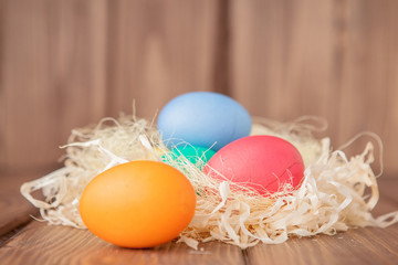 Colorful Easter eggs on wooden background with copy space