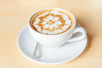 hot cappuccino coffee with nice pattern foam on table