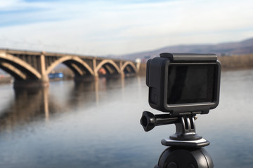 action camera on a tripod, cityscape, bridge